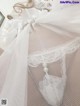 A close up of a white lingerie on a bed.