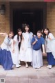 A group of young women standing in front of a building.