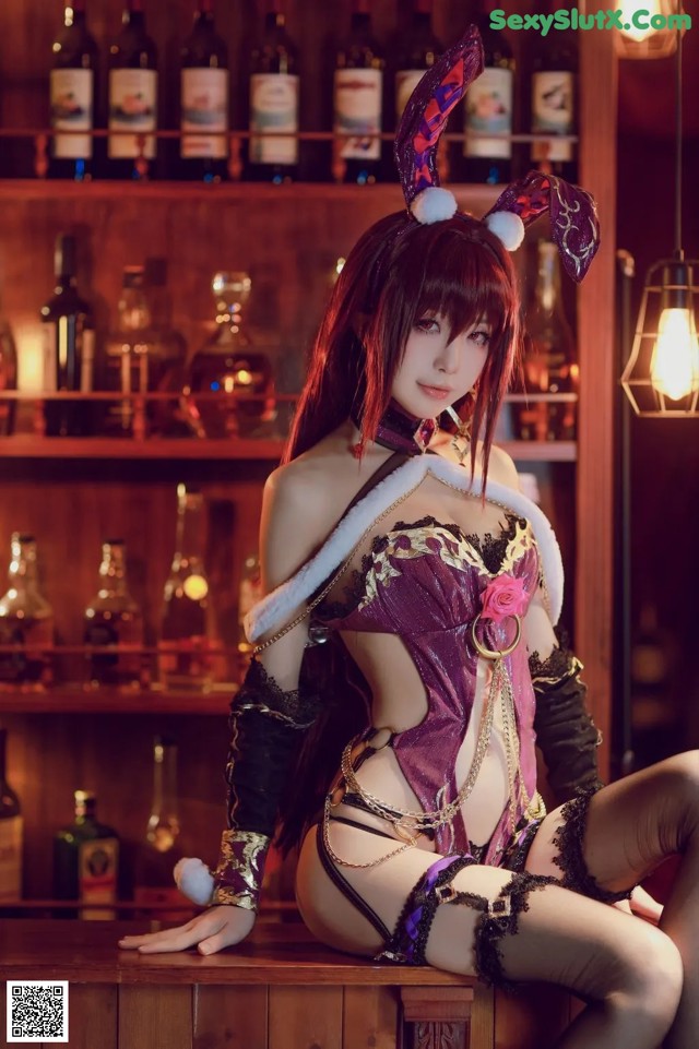 A woman in a bunny costume sitting on a bar.