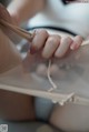 A close up of a woman's hands holding a piece of fabric.