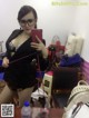 A woman taking a selfie in a mirror.