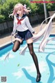 A girl in a school uniform jumping into a swimming pool.