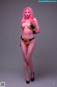 A woman with pink hair in a bikini posing for a picture.