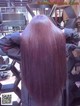 A woman with long brown hair sitting in a salon.