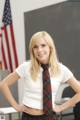 A woman in a school uniform posing for a picture.