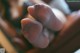 A close up of a person's foot with a string attached to it.