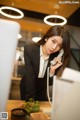 A woman in a business suit talking on a phone.