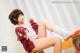 A woman sitting on top of a wooden chair.